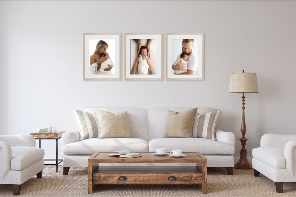 family newborn photos displayed in three large oak frames in modern provicial living room